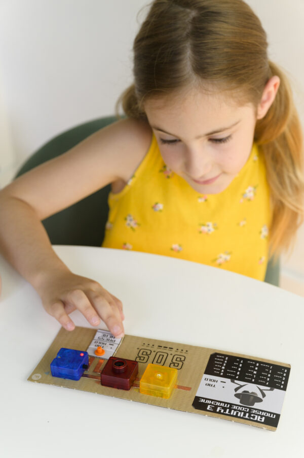 Happy child playing with the finished product from our 4M TechCraft Paper Circuit Science